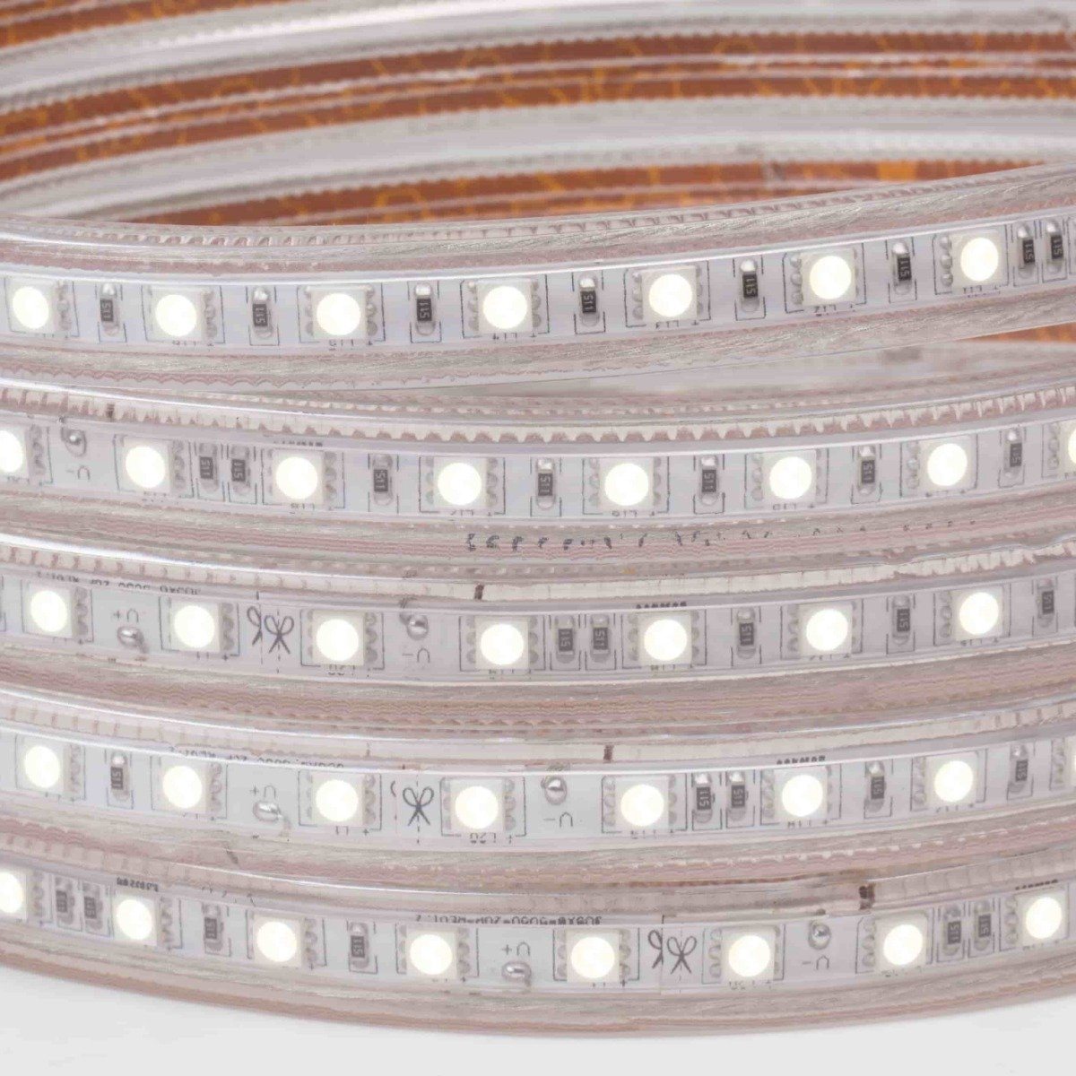120V led strip lights on white background coiled five times with illuminated white color led chips and cap seal at end
