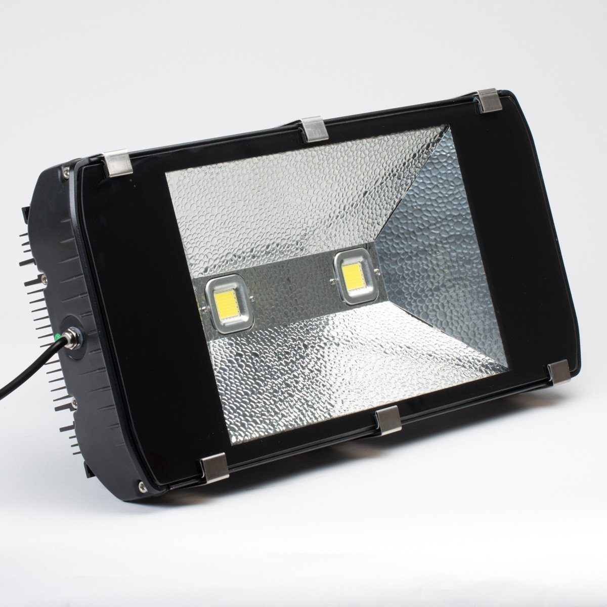 angled view of rectangular outdoor led flood light in black housing with clear front lens and visible led chips in center