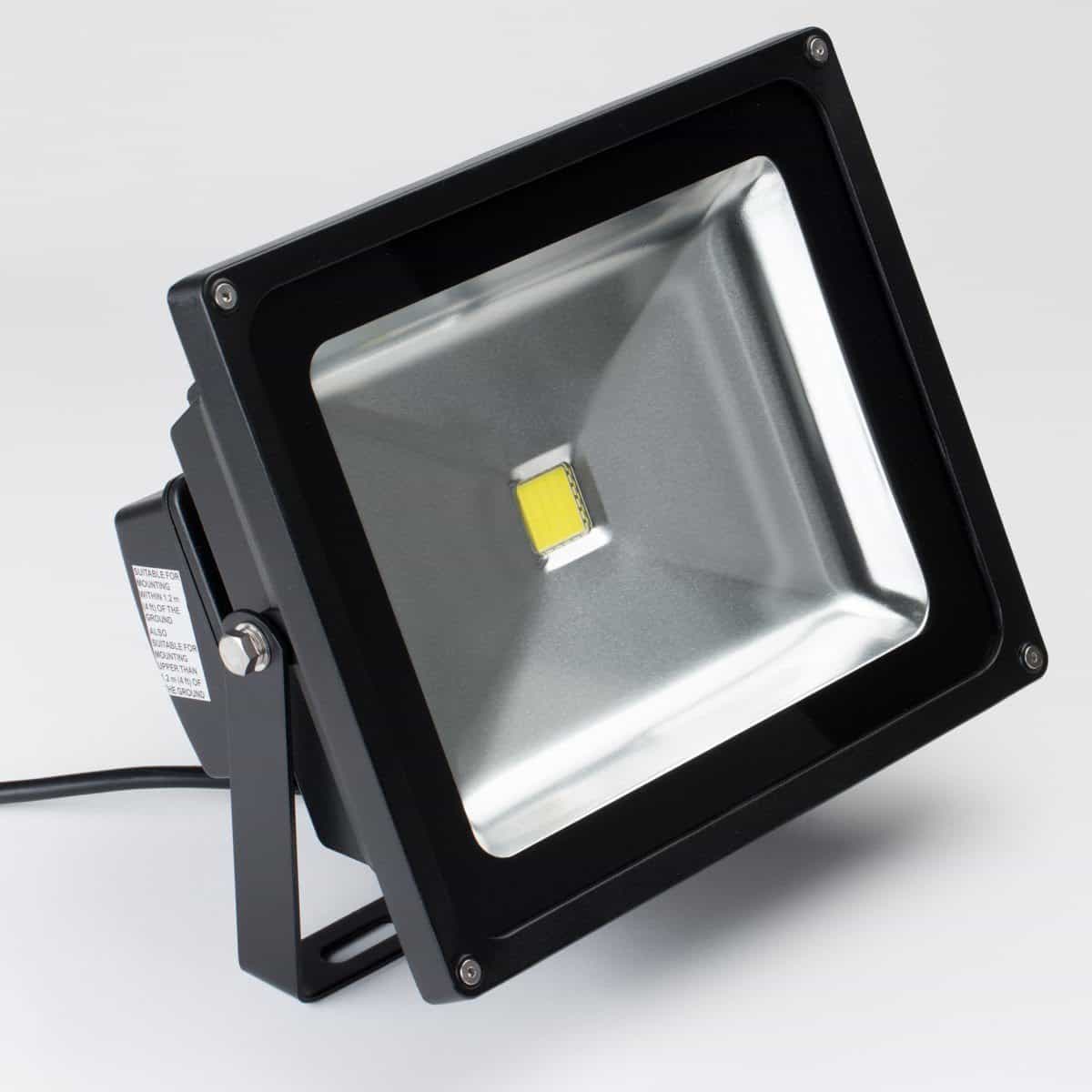 small led flood light in black housing with visible yellow chip in center
