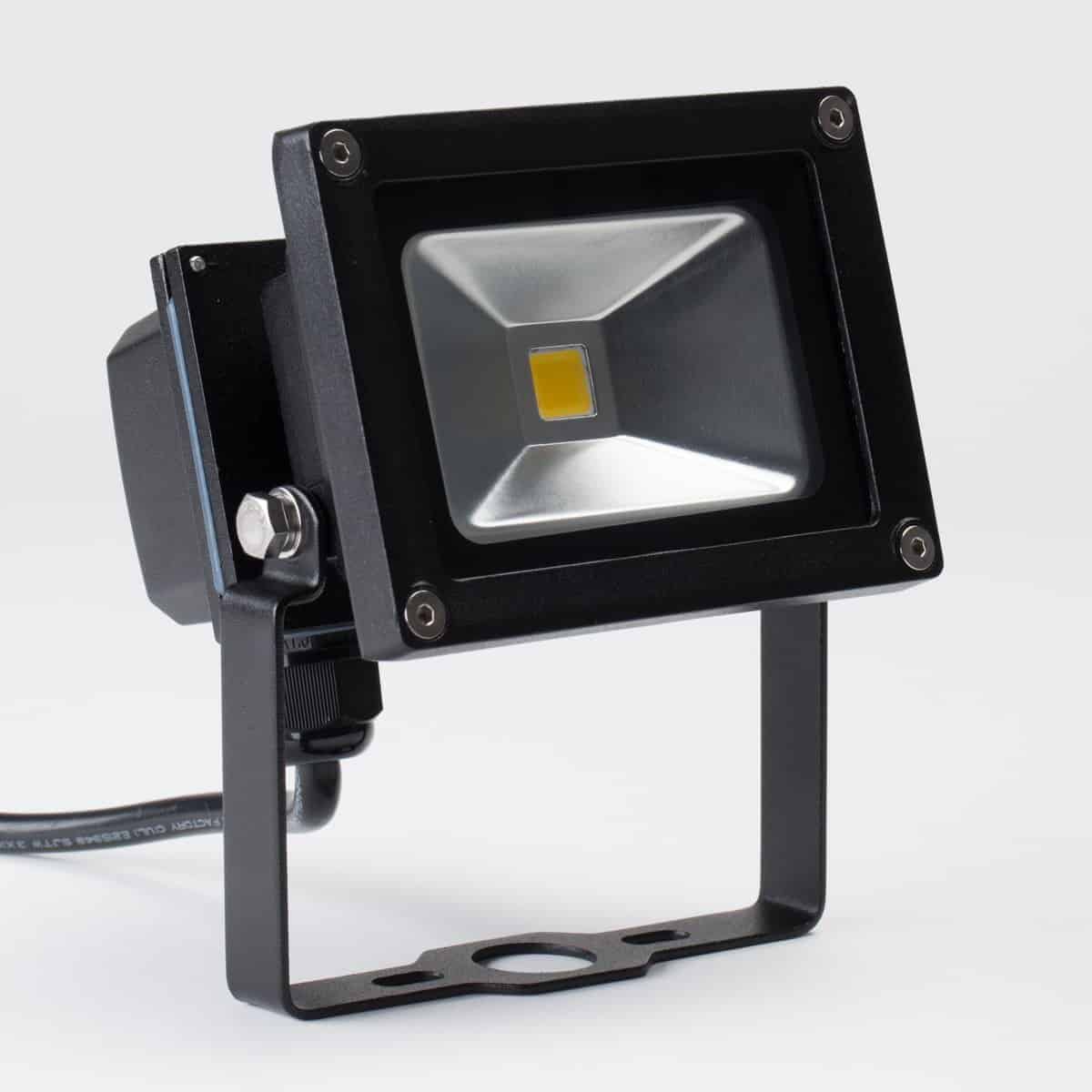small led flood light in black housing with mounting bracket and yellow chip in center