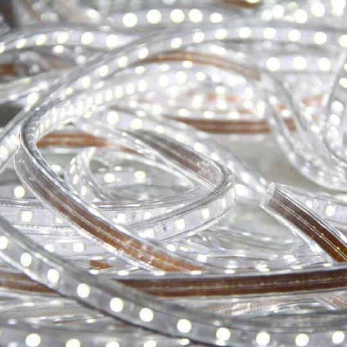 close up of led strip light uncoiled on floor and brightly illuminated in a cool white 5500k color temperature