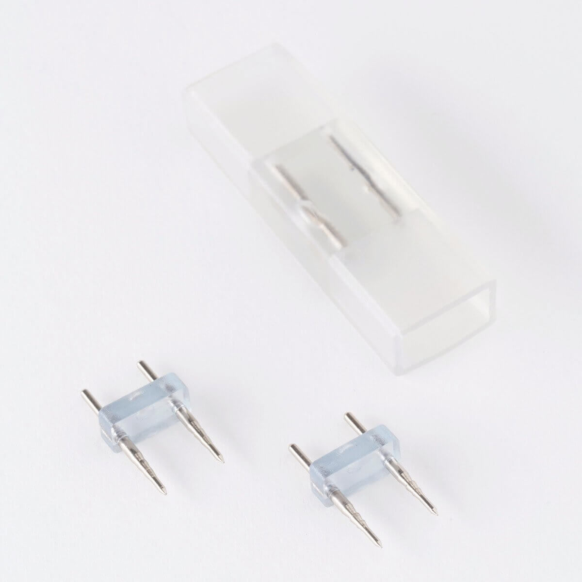 clear silicone led strip light splice connector with visible silver internal wiring and two led pins