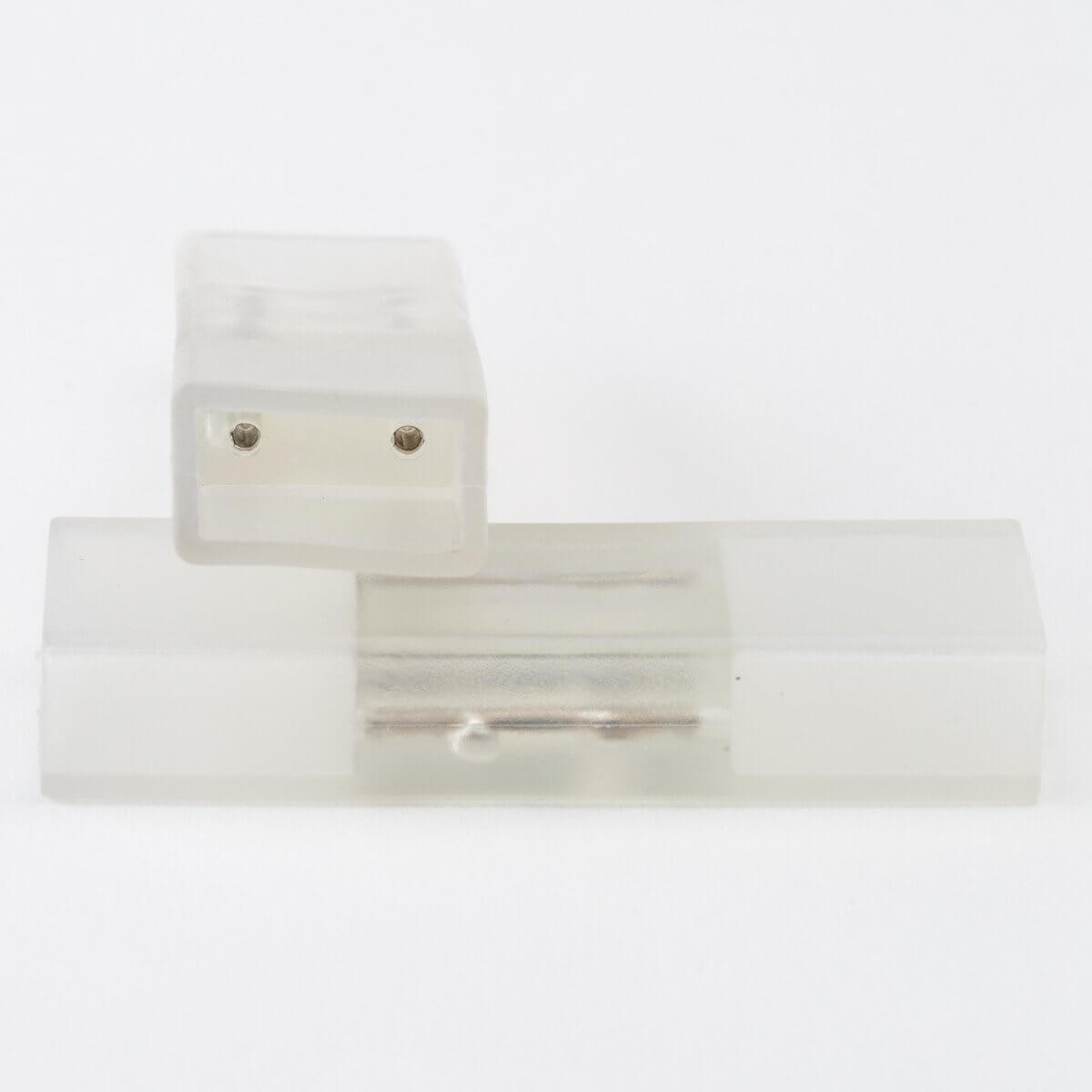 two clear silicone led strip light splice connectors stacked, top connector has two visible holes