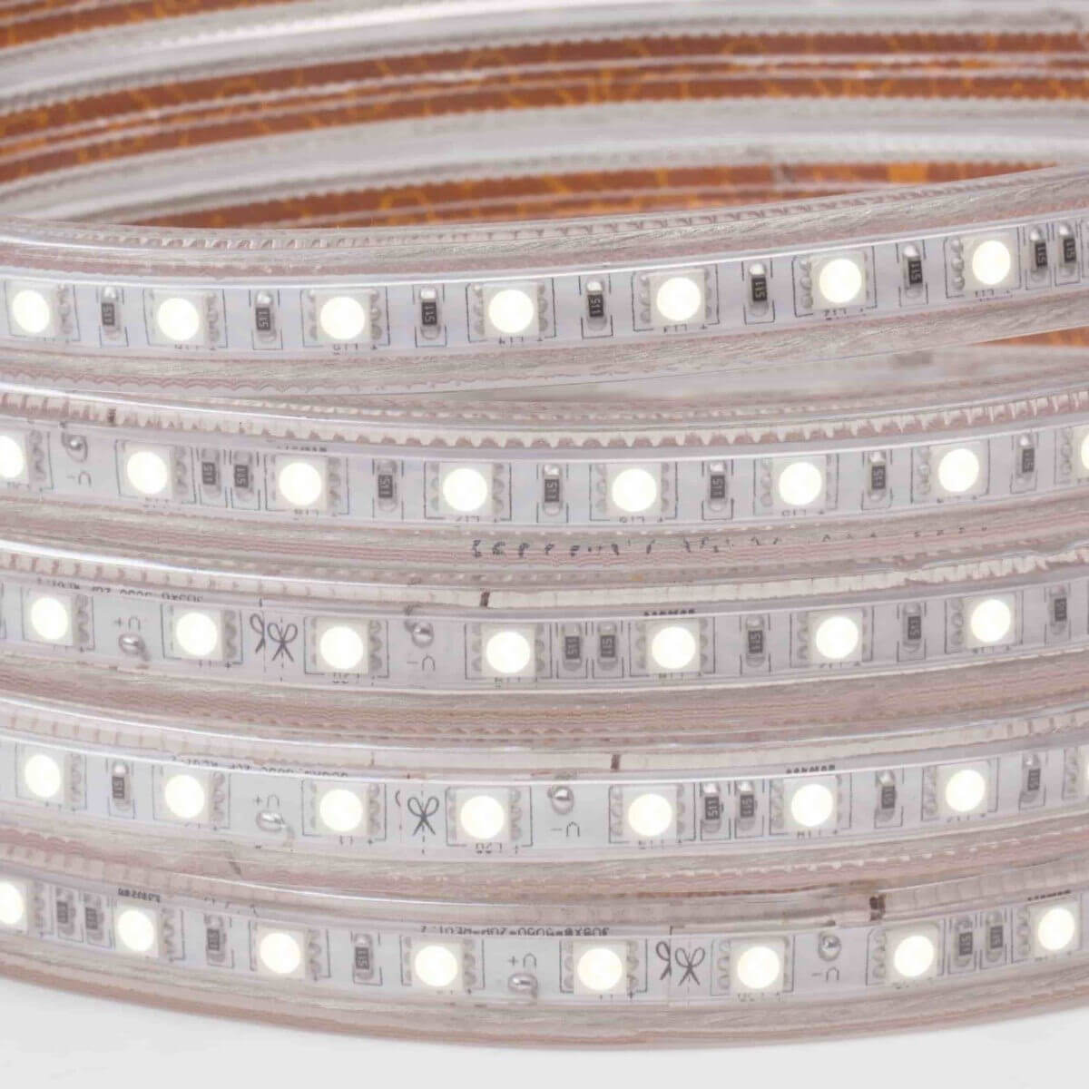 120V led strip lights on white background coiled five times with illuminated white color led chips and cap seal at end