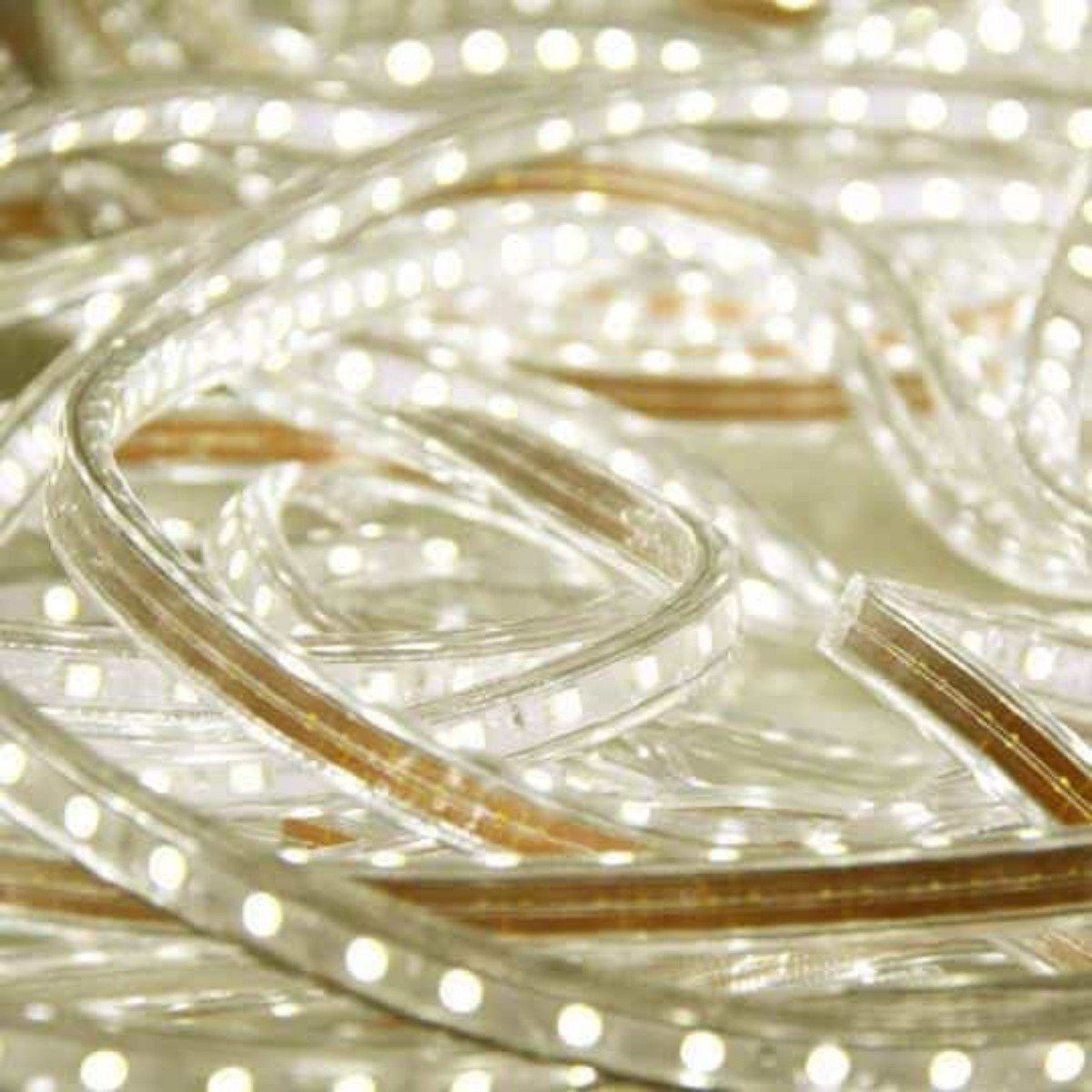 close up of led strip light uncoiled on floor and brightly illuminated in a warm white 3000k color temperature
