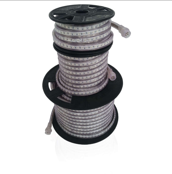 led strip light reels with visible chips and power feed in 3 sizes stacked from largest at bottom to smallest on top