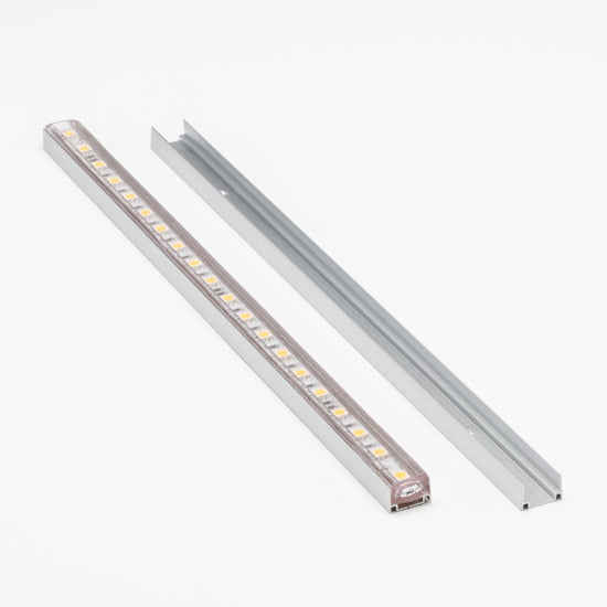 two aluminum u channel tracks, one with an led strip light laid in