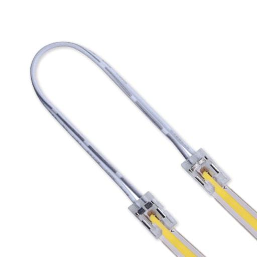 white solderless connector cable with clips on ends bent in u shape with cob led strip inserted in each end
