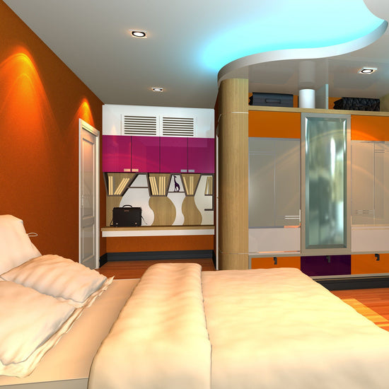hotel room with orange wall and pink accents illuminated by cool white strip light in above soffit