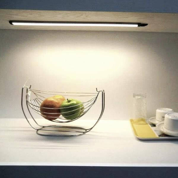 
                      
                        under cabinet kitchen area with fruit basket and dishes illuminated by linear led light bars
                      
                    